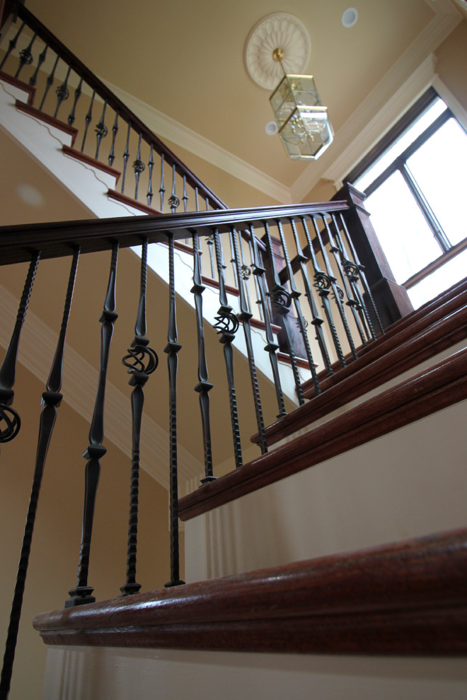 Inspiration for a huge timeless wooden curved mixed material railing staircase remodel in DC Metro with wooden risers
