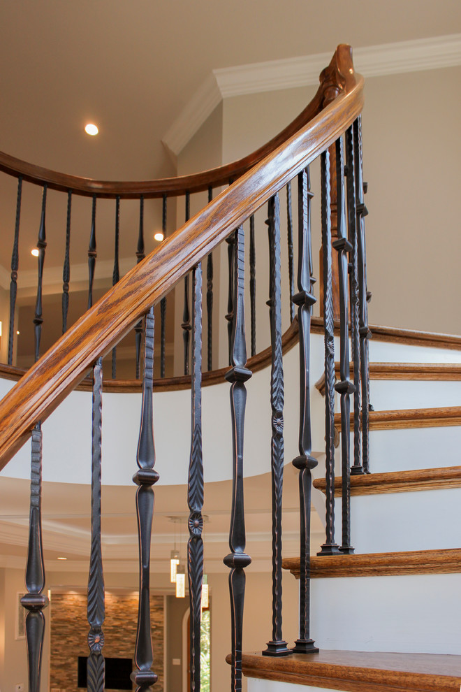 Staircase - large mediterranean wooden curved mixed material railing staircase idea in DC Metro with wooden risers