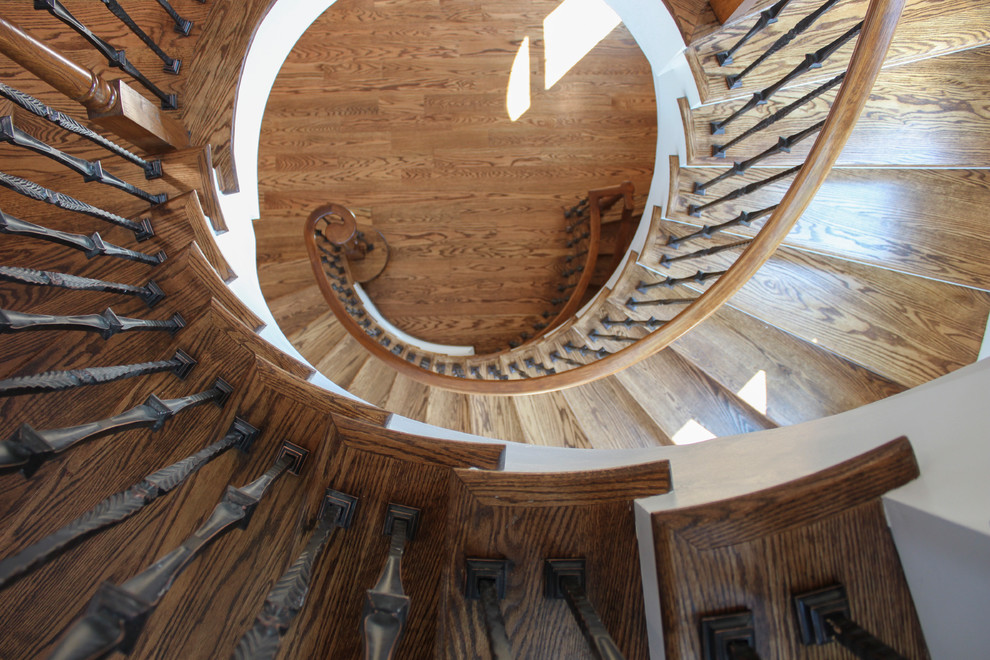 Inspiration for a large mediterranean wood curved mixed railing staircase in DC Metro with wood risers.