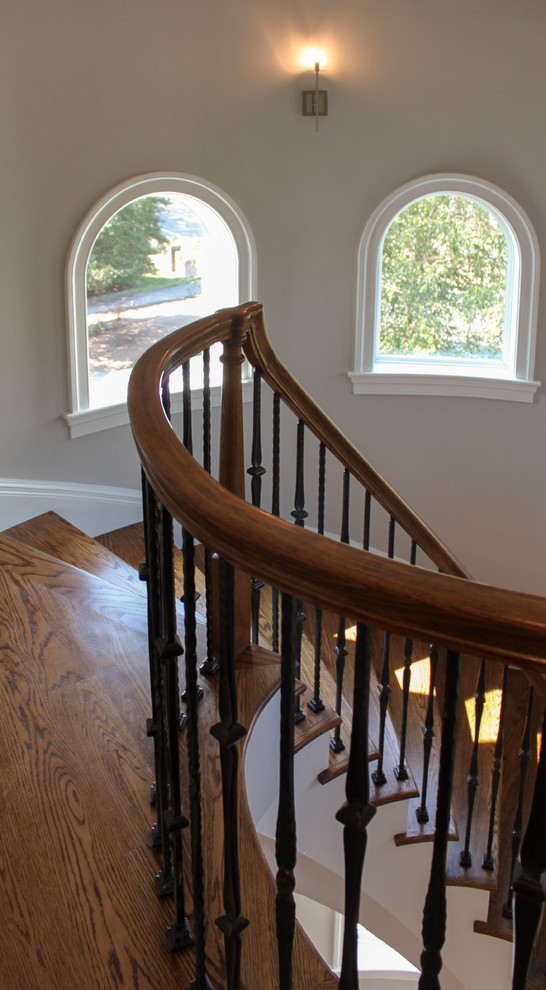 Staircase - large mediterranean wooden curved mixed material railing staircase idea in DC Metro with wooden risers