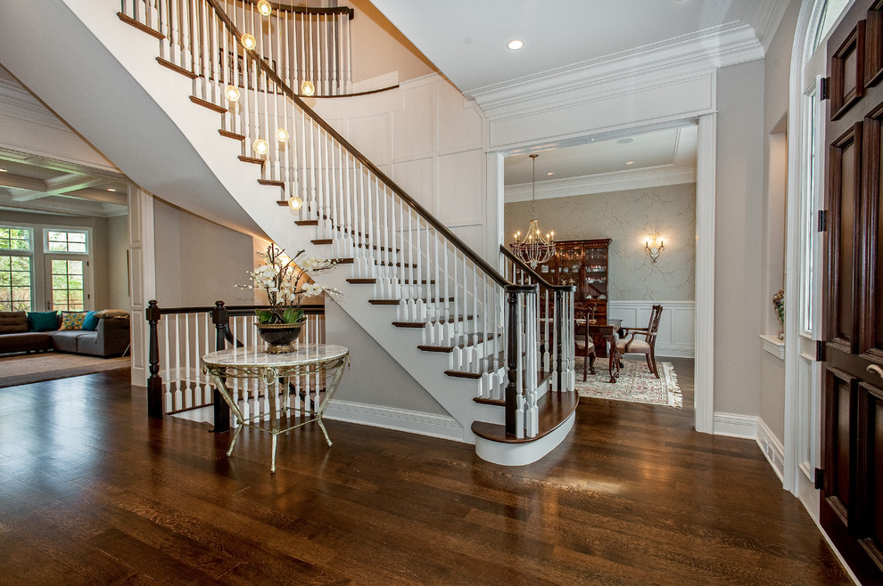 Inspiration for a large timeless wooden curved wood railing staircase remodel in Chicago with painted risers