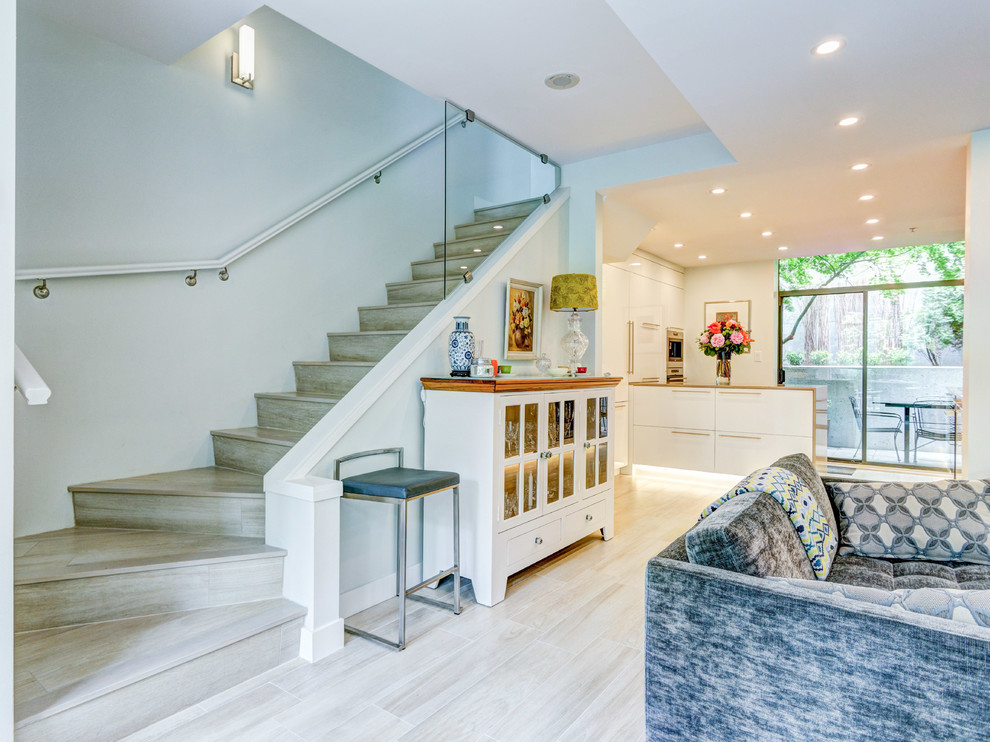 Large contemporary tiled l-shaped staircase in Vancouver with tiled risers.