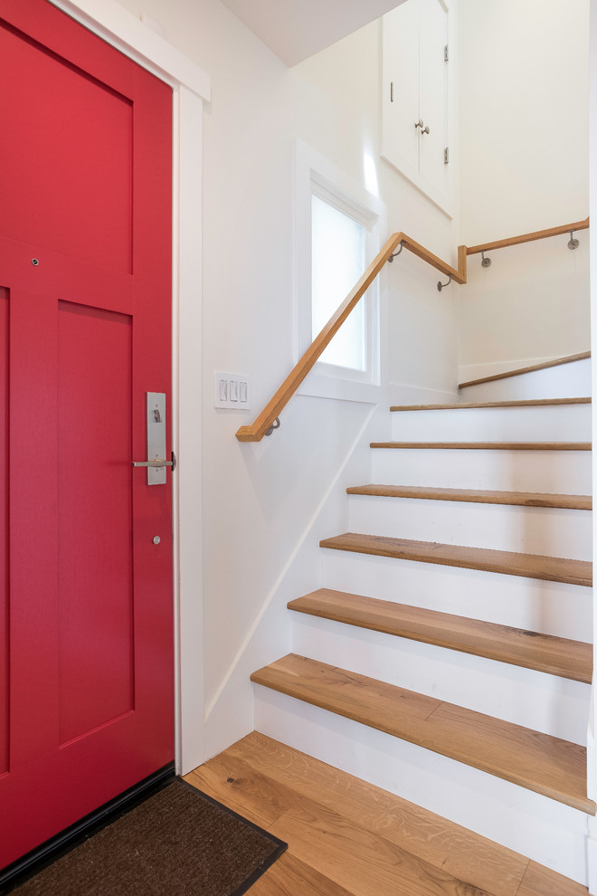 Imagen de escalera en U clásica de tamaño medio con escalones de madera, contrahuellas de madera y barandilla de madera