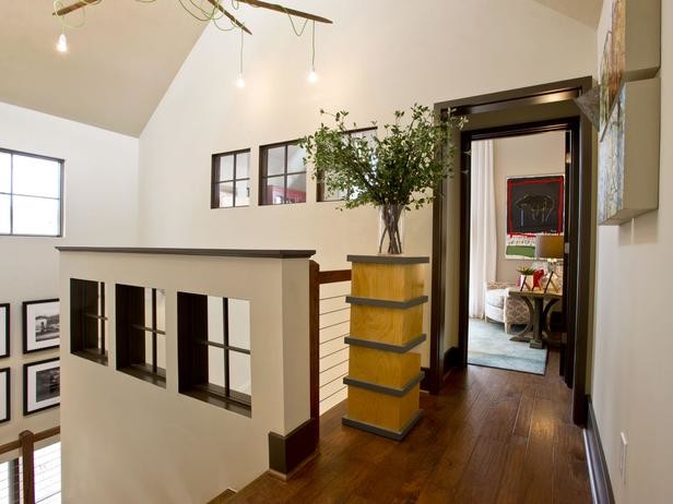 Foto de escalera en U de estilo de casa de campo de tamaño medio sin contrahuella con escalones de madera y barandilla de madera