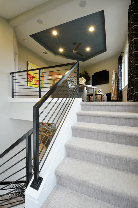 Photo of a medium sized contemporary carpeted u-shaped staircase in Austin with carpeted risers.