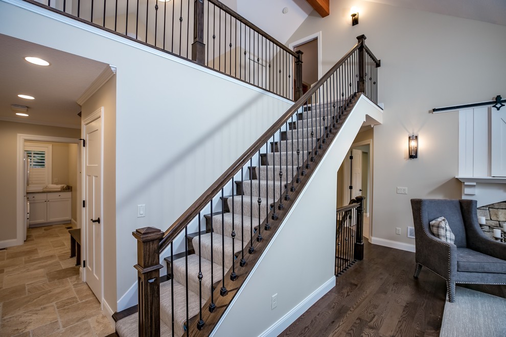 Staircase - mid-sized transitional carpeted straight staircase idea in Minneapolis with carpeted risers