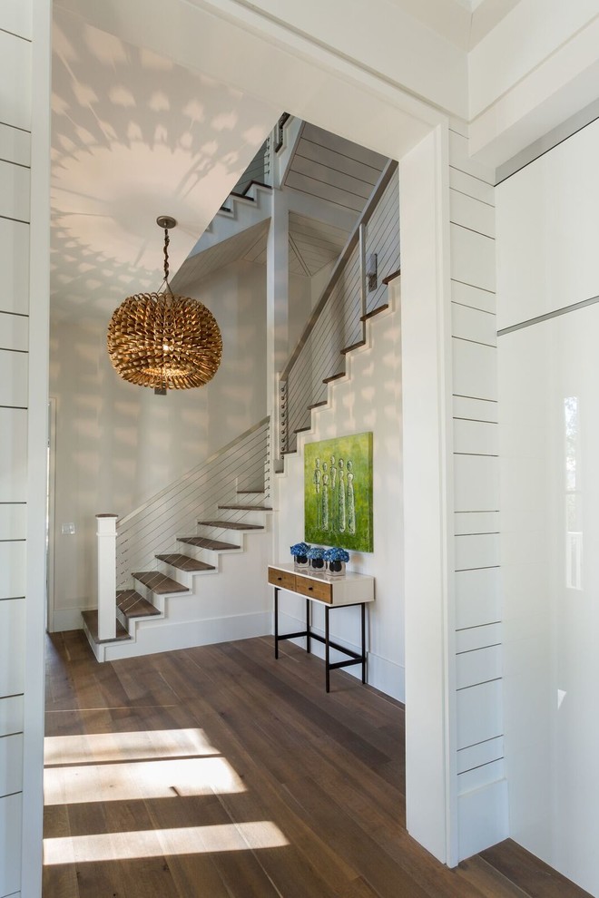 Inspiration for a medium sized contemporary wood u-shaped wire cable railing staircase in Charleston with painted wood risers.