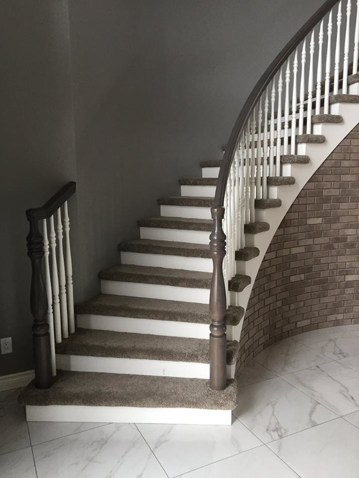 Elegant carpeted curved staircase photo in Other with painted risers
