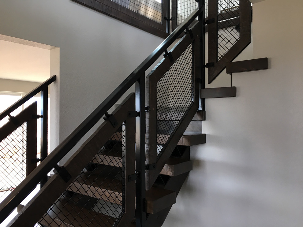 Inspiration for a medium sized industrial wood l-shaped metal railing staircase in Other with open risers.