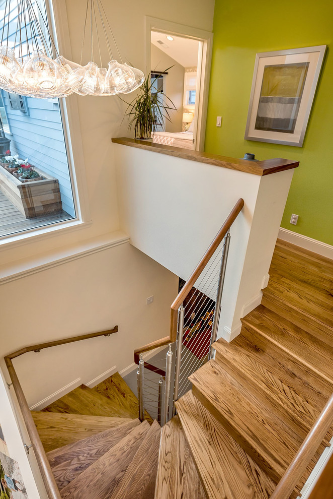 Photo of a small midcentury wood spiral staircase in San Francisco with wood risers.