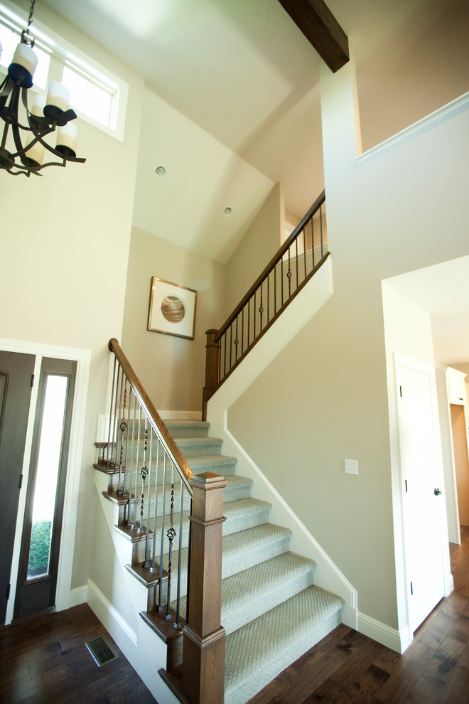Example of a mid-sized transitional carpeted u-shaped staircase design in Other with carpeted risers