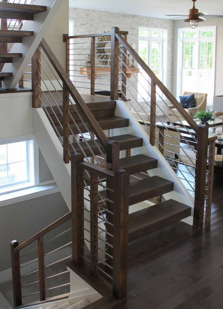 Diseño de escalera en U contemporánea grande con escalones de madera y barandilla de varios materiales