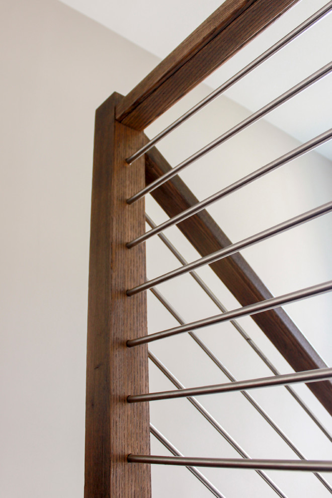 Стильный дизайн: большая п-образная лестница в современном стиле с деревянными ступенями и перилами из смешанных материалов - последний тренд