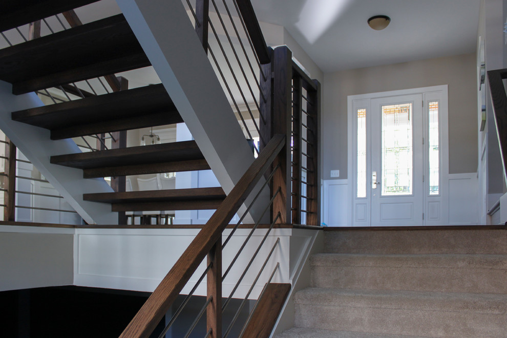 Imagen de escalera en U contemporánea grande con escalones de madera y barandilla de varios materiales