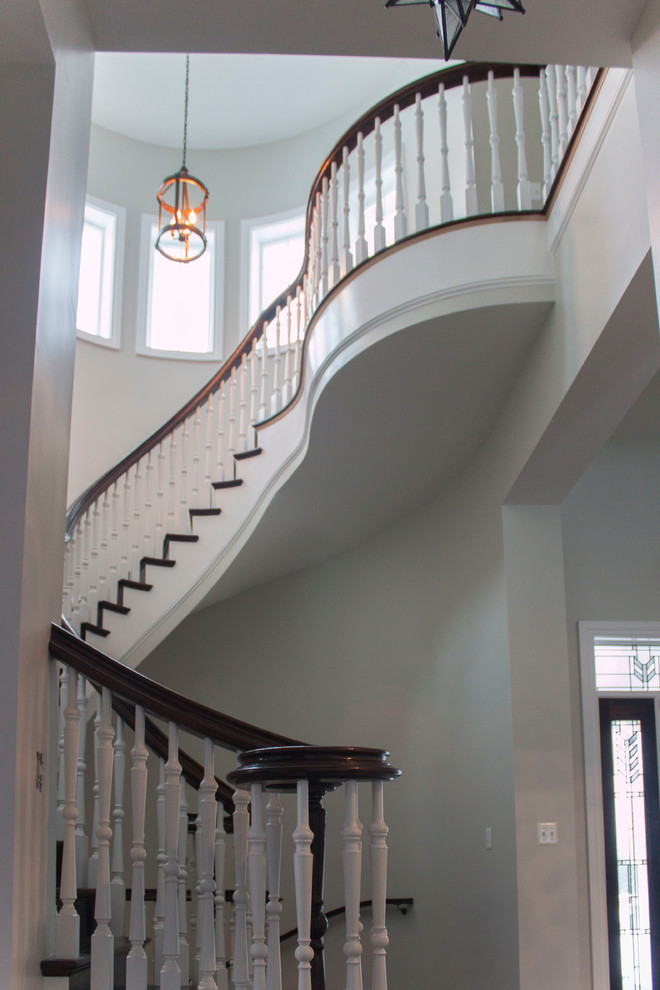 Inspiration for a large transitional wooden spiral wood railing staircase remodel in DC Metro with wooden risers