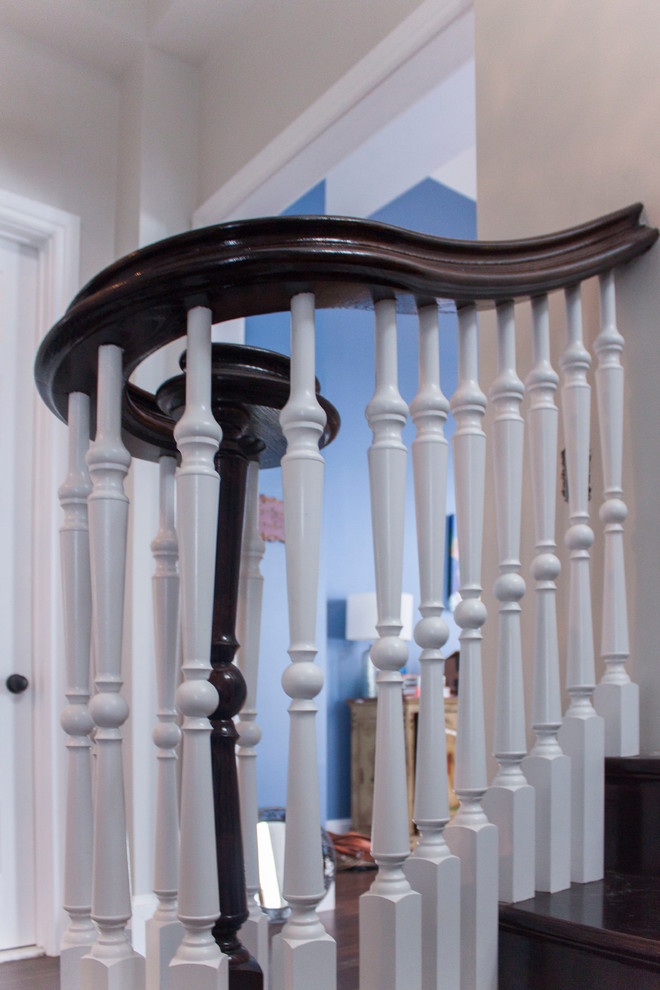 Large transitional wooden spiral wood railing staircase photo in DC Metro with wooden risers