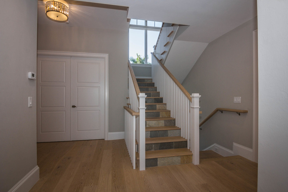 Staircase - mid-sized traditional wooden u-shaped staircase idea in Phoenix with tile risers