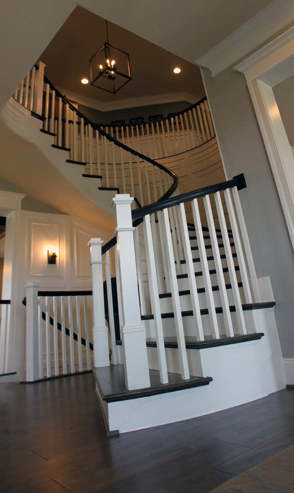 Inspiration for a huge eclectic wooden curved wood railing staircase remodel in DC Metro with wooden risers