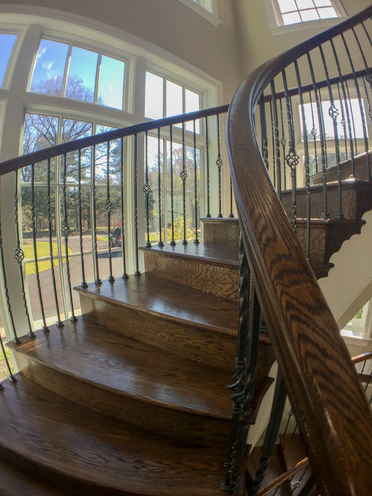Inspiration for an expansive classic wood spiral mixed railing staircase in DC Metro with wood risers.