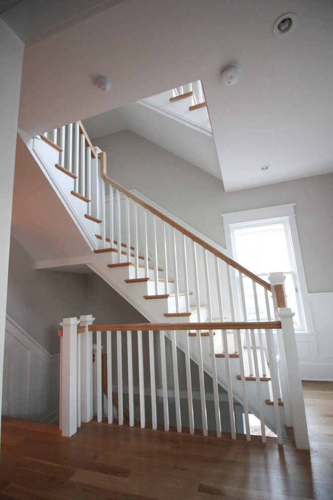 Photo of a large vintage wood l-shaped wood railing staircase in DC Metro with wood risers.