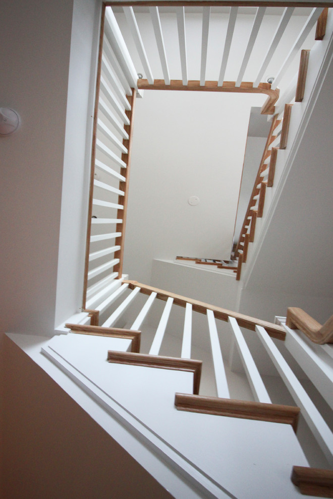 Idées déco pour un grand escalier romantique en L avec des contremarches en bois, des marches en bois et un garde-corps en bois.