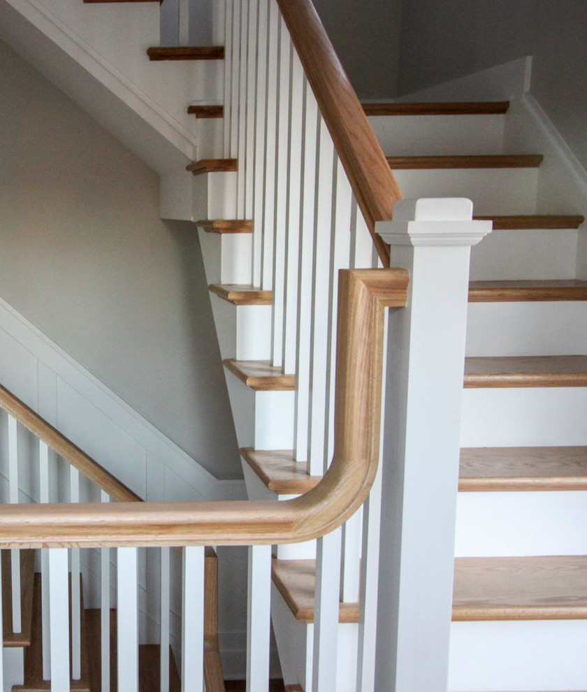 This is an example of a large vintage wood l-shaped wood railing staircase in DC Metro with wood risers.