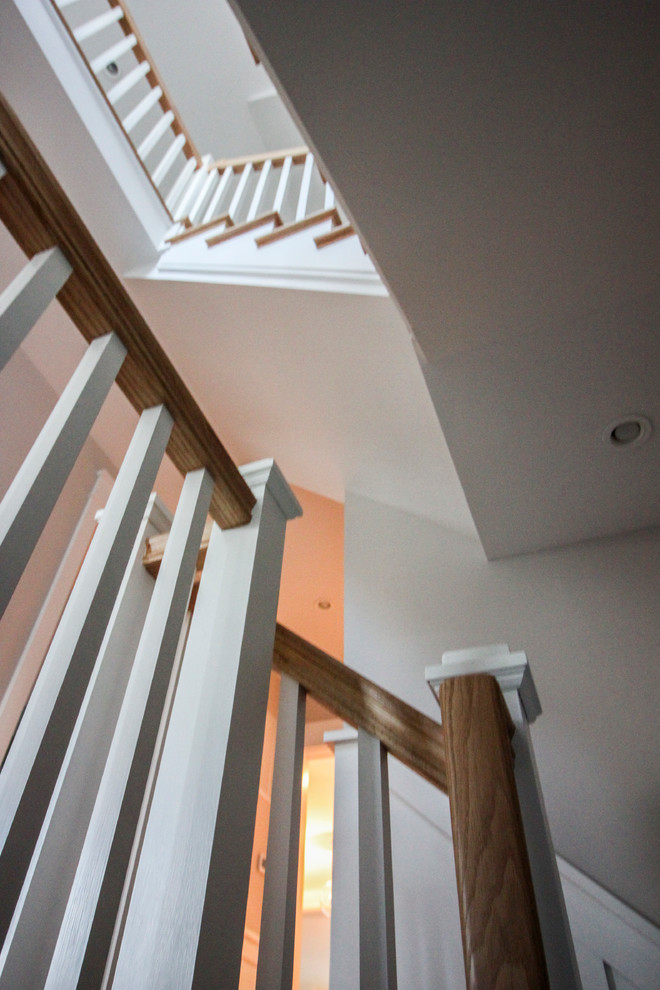 Example of a large cottage chic wooden l-shaped wood railing staircase design in DC Metro with wooden risers