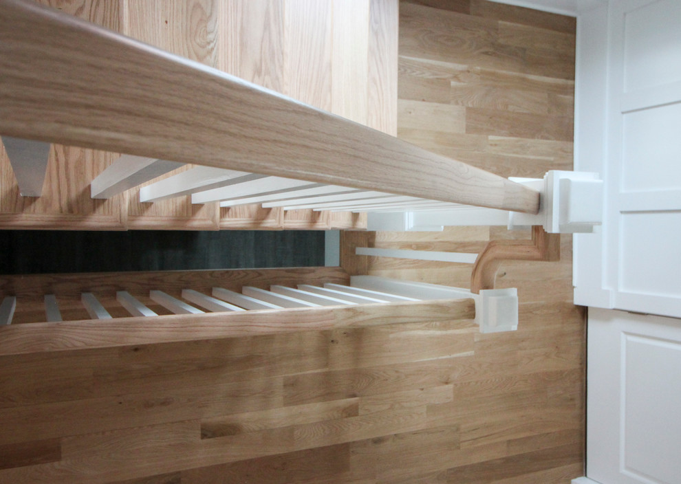 Large romantic wood l-shaped wood railing staircase in DC Metro with wood risers.
