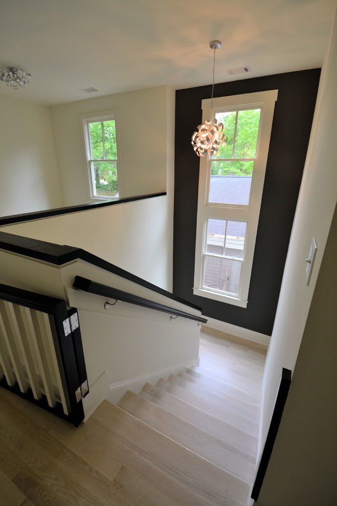 Design ideas for a medium sized contemporary painted wood u-shaped wood railing staircase in Atlanta with wood risers.