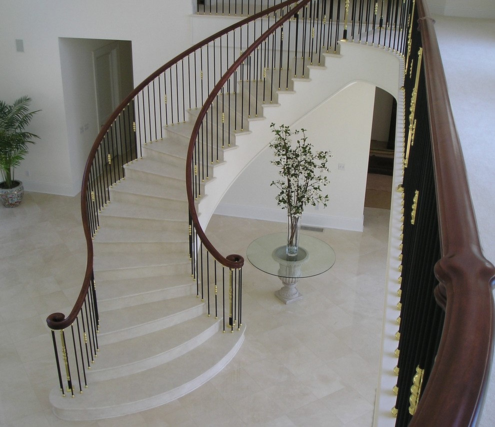 Example of a large classic wooden curved mixed material railing staircase design in DC Metro with wooden risers