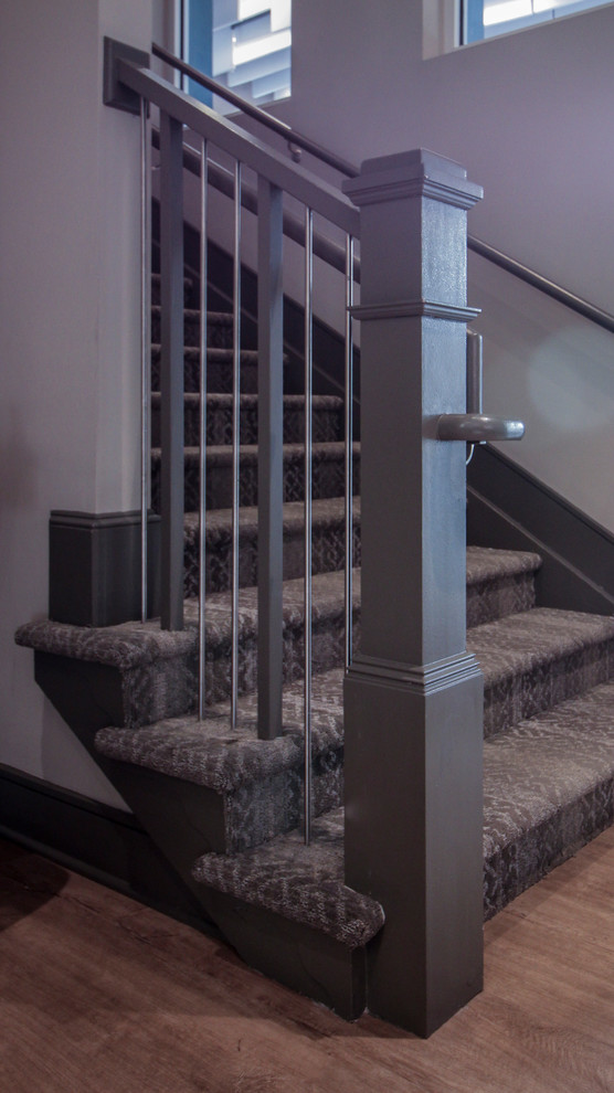 Photo of a small industrial wood u-shaped metal railing staircase in DC Metro with wood risers.