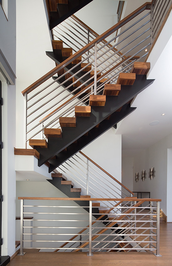 Inspiration for a large modern wooden u-shaped open staircase remodel in Chicago