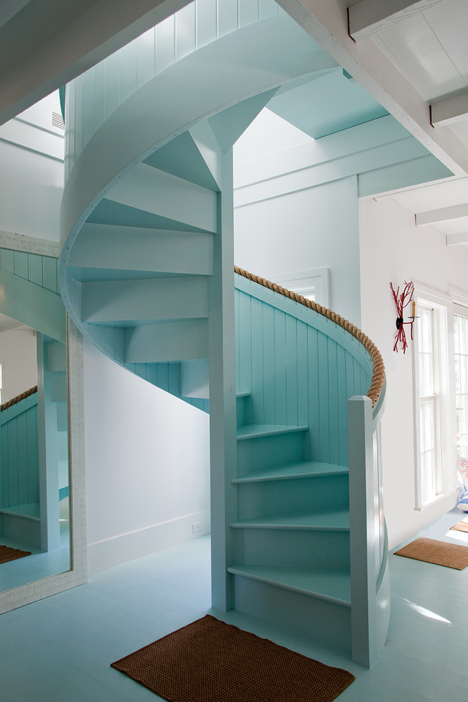 Photo of a beach style painted wood spiral staircase in Philadelphia with painted wood risers.