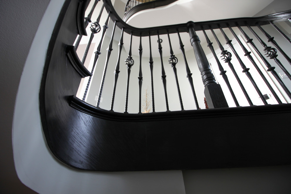 Ejemplo de escalera curva tradicional renovada extra grande con escalones de madera, contrahuellas de madera y barandilla de varios materiales
