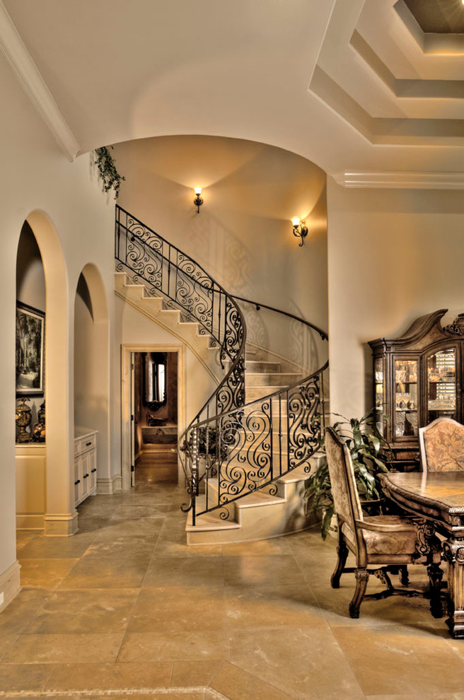 Photo of a mediterranean concrete curved staircase in New Orleans with concrete risers.