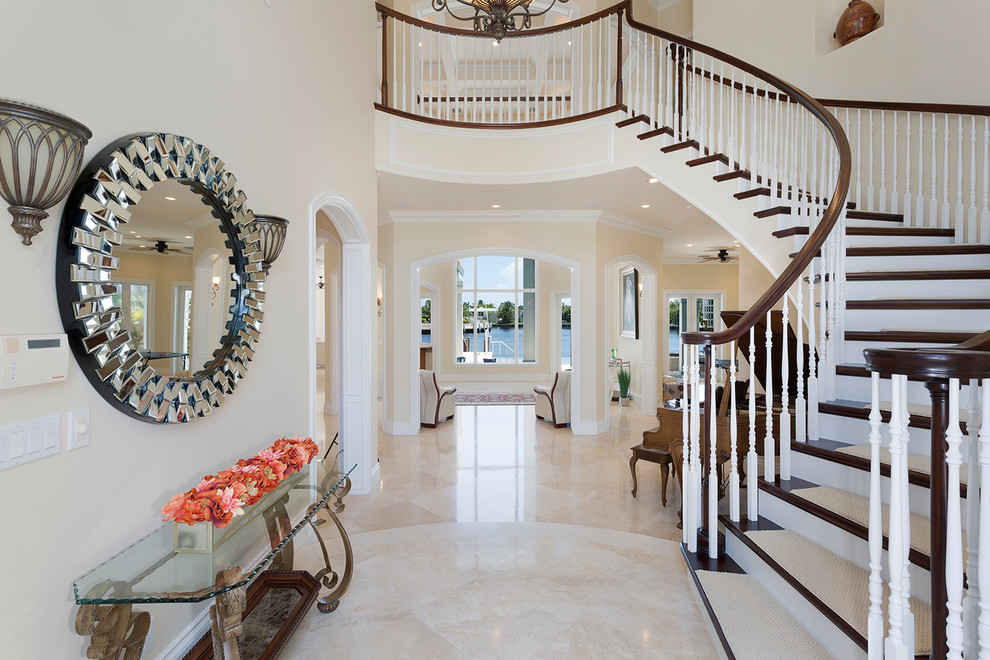 Photo of an expansive traditional painted wood spiral wood railing staircase in Miami with wood risers.