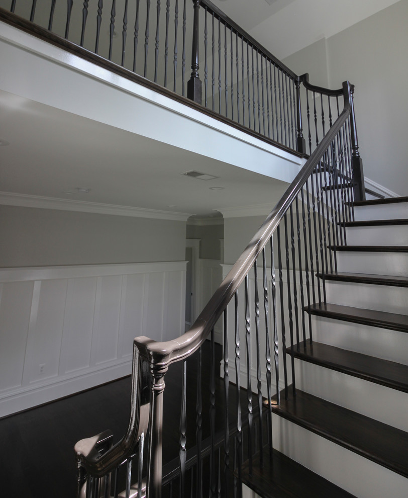 Large traditional wood floating mixed railing staircase in DC Metro with wood risers.