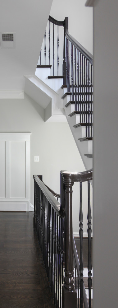 Inspiration for a large classic wood floating mixed railing staircase in DC Metro with wood risers.