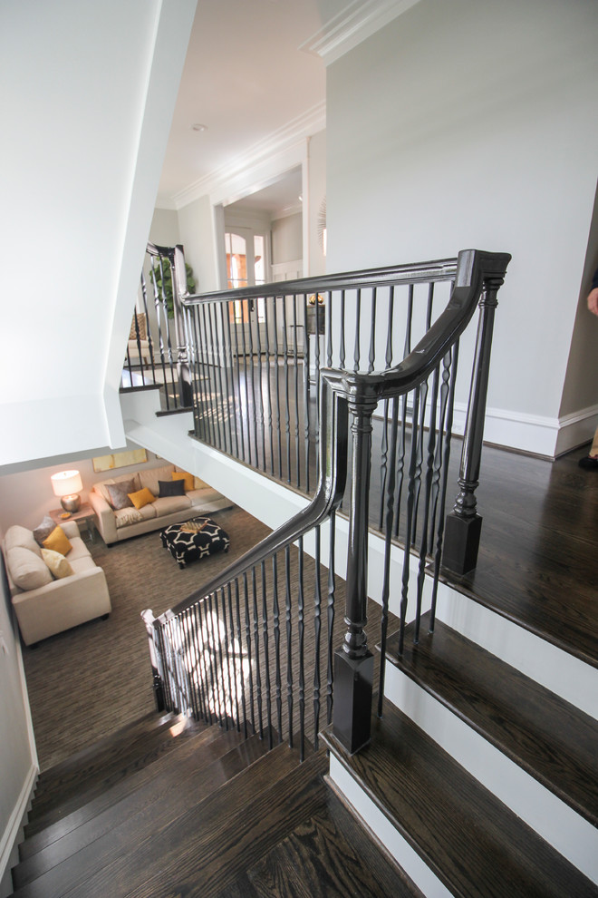 Inspiration for a large transitional wooden floating mixed material railing staircase remodel in DC Metro with wooden risers