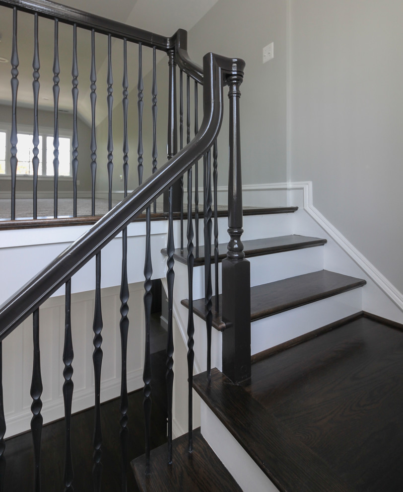 This is an example of a large classic wood floating mixed railing staircase in DC Metro with wood risers.