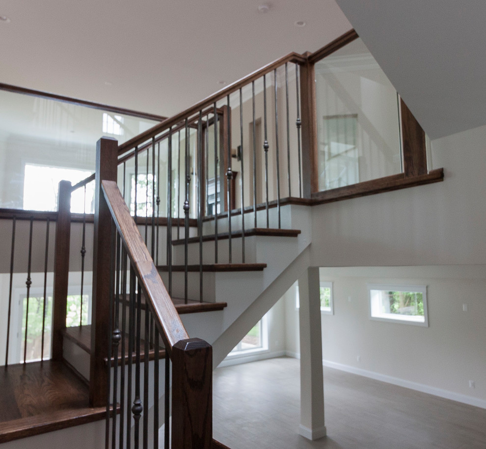 Inspiration for a huge contemporary wooden floating glass railing staircase remodel in DC Metro with wooden risers