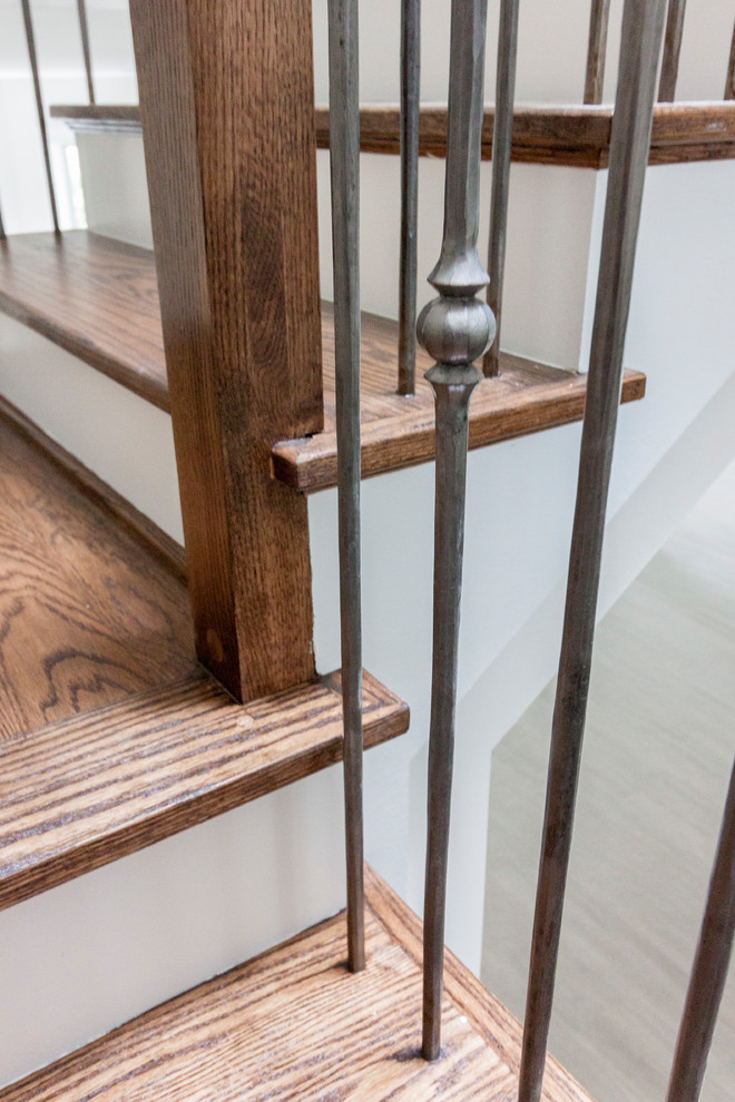 Huge trendy wooden floating glass railing staircase photo in DC Metro with wooden risers