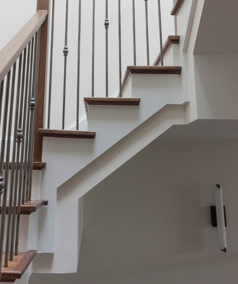 This is an example of an expansive contemporary wood floating glass railing staircase in DC Metro with wood risers.
