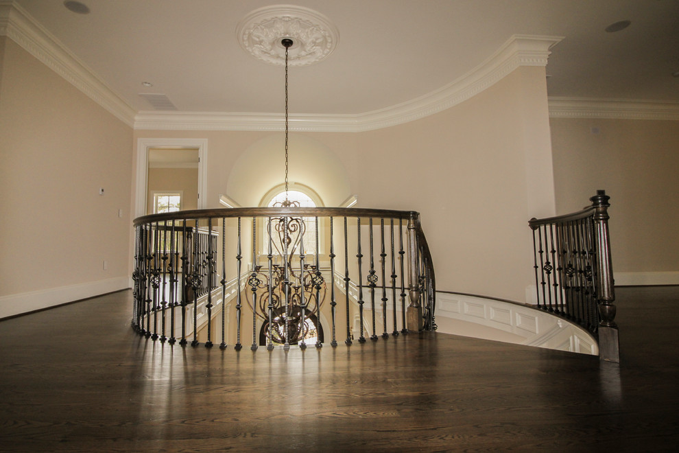 Inspiration for a mid-sized timeless wooden curved mixed material railing staircase remodel in DC Metro with wooden risers