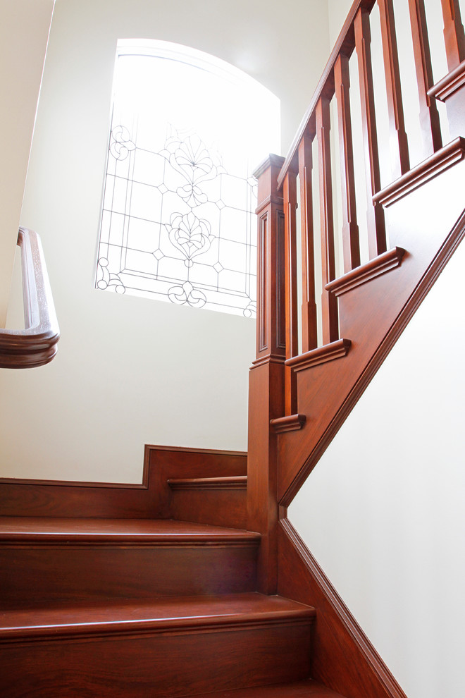 Example of a mid-sized classic wooden curved staircase design in Orange County with wooden risers