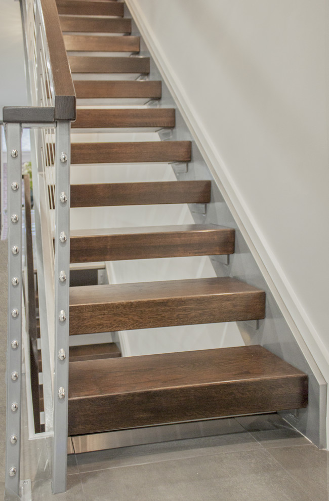 Example of a large trendy wooden straight mixed material railing staircase design in DC Metro