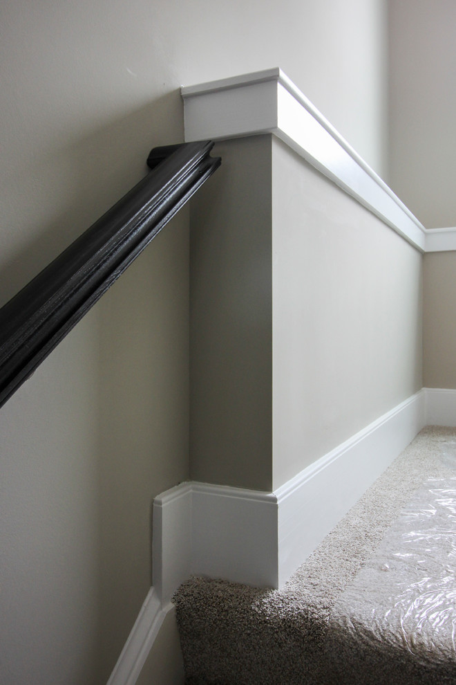 Photo of a large modern wood u-shaped wood railing staircase in DC Metro with wood risers.