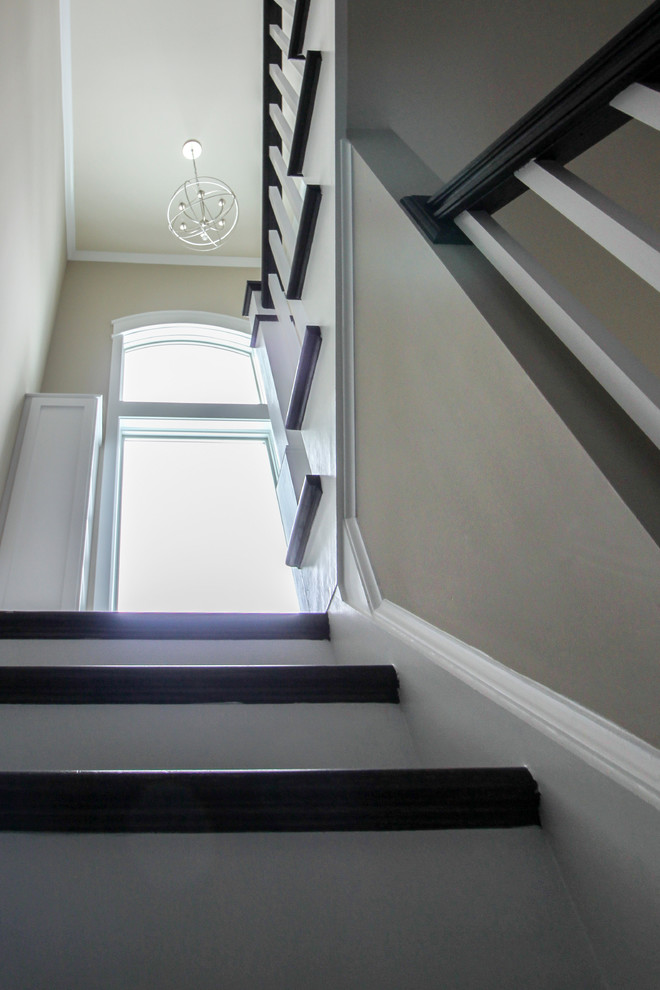 Ejemplo de escalera en U minimalista grande con escalones de madera, contrahuellas de madera y barandilla de madera