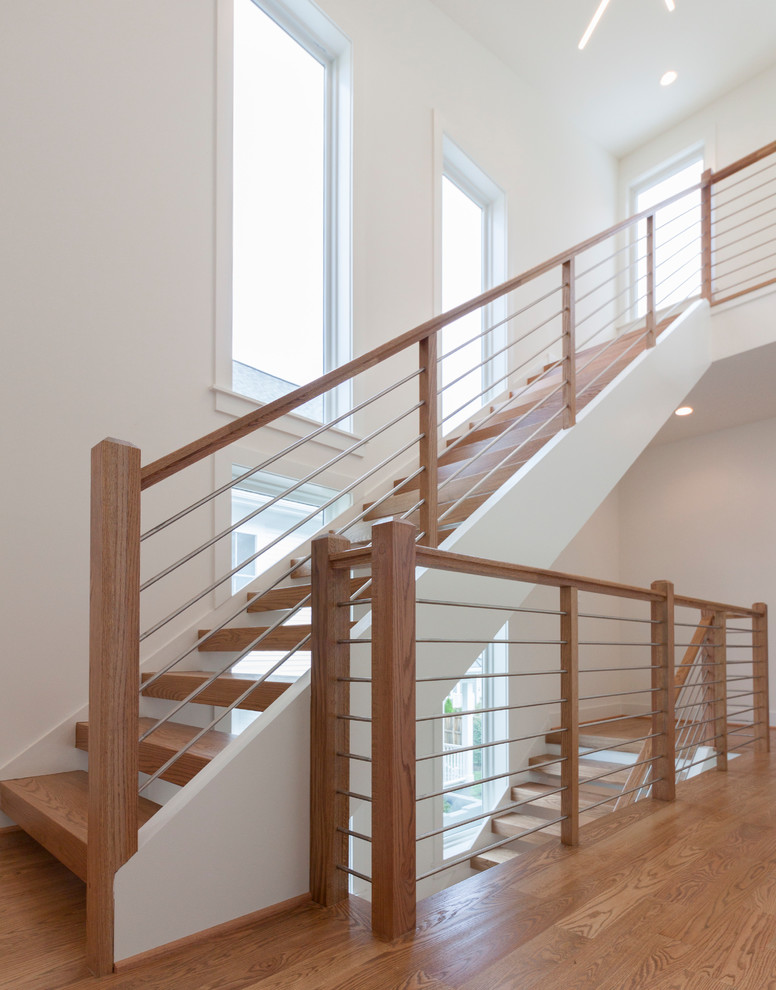 Large trendy wooden floating mixed material railing staircase photo in DC Metro