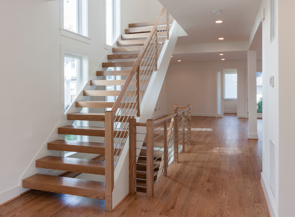 Inspiration for a large contemporary wood floating mixed railing staircase in DC Metro.